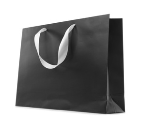 Photo of Paper shopping bag with ribbon handles on white background. Mockup for design