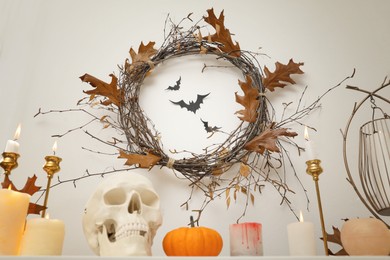 Photo of Different Halloween decor on table indoors. Festive interior
