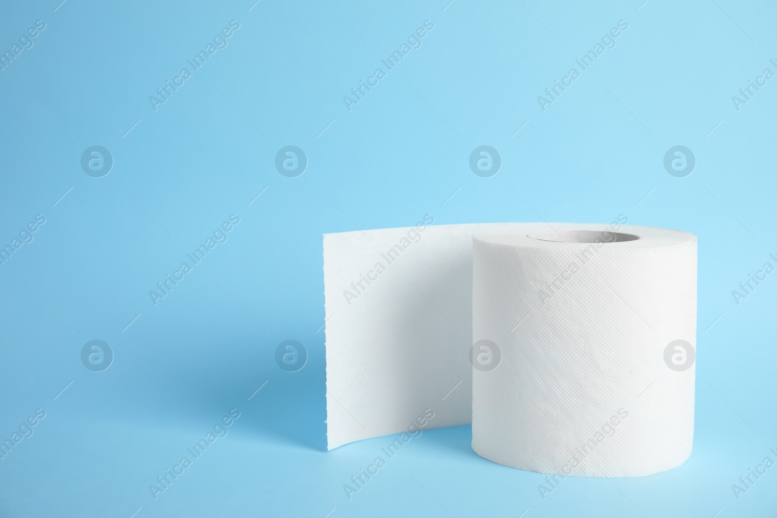 Photo of Toilet paper roll on color background. Space for text