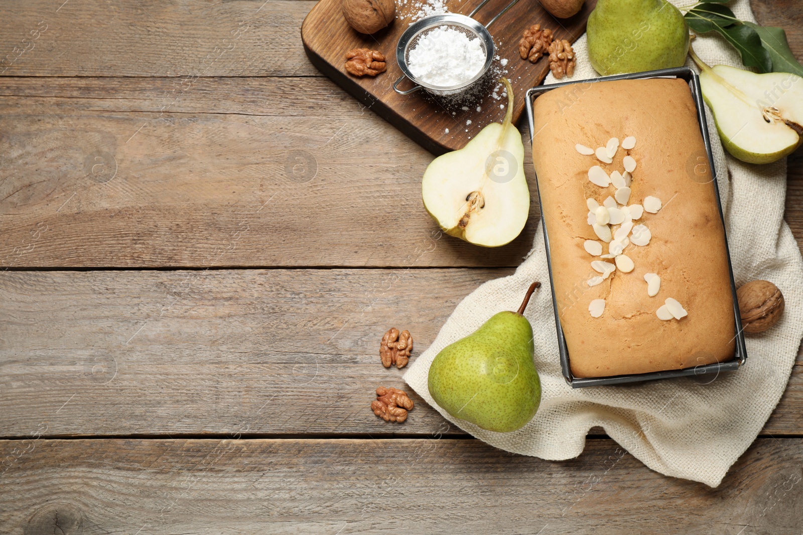 Photo of Flat lay composition with pear bread on wooden table, space for text. Homemade cake