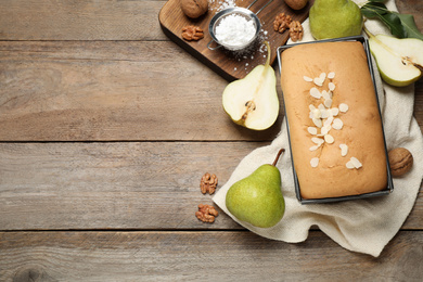 Flat lay composition with pear bread on wooden table, space for text. Homemade cake