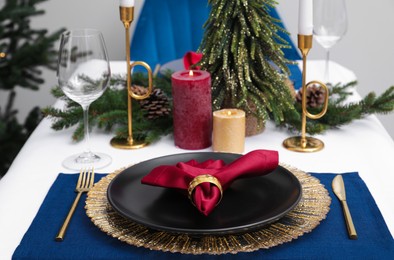 Festive place setting with beautiful dishware, cutlery and fabric napkin for Christmas dinner on white table