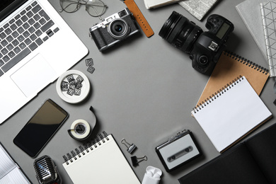 Photo of Flat lay composition with equipment for journalist on grey table, space for text