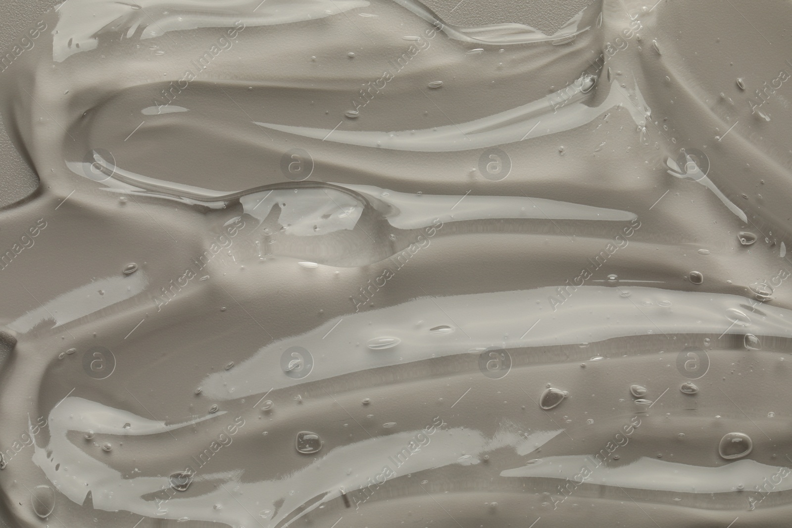 Photo of Clear cosmetic gel on grey background, top view