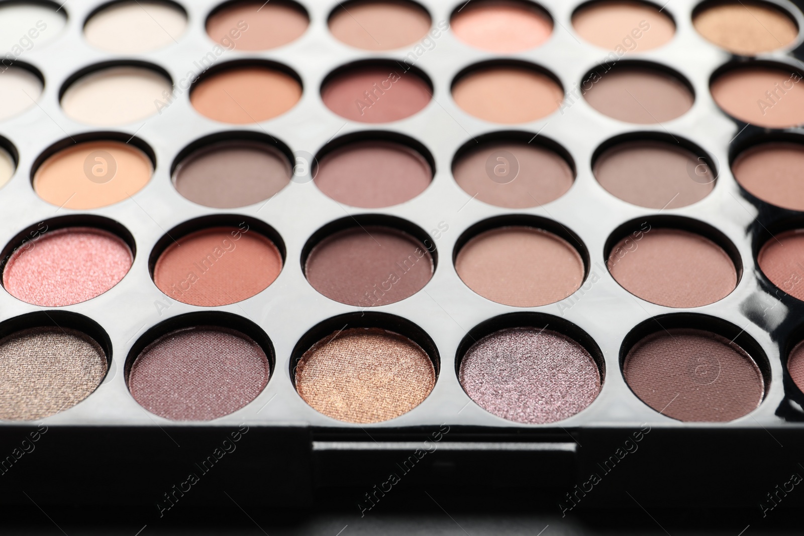 Photo of Beautiful eye shadow palette on table, closeup