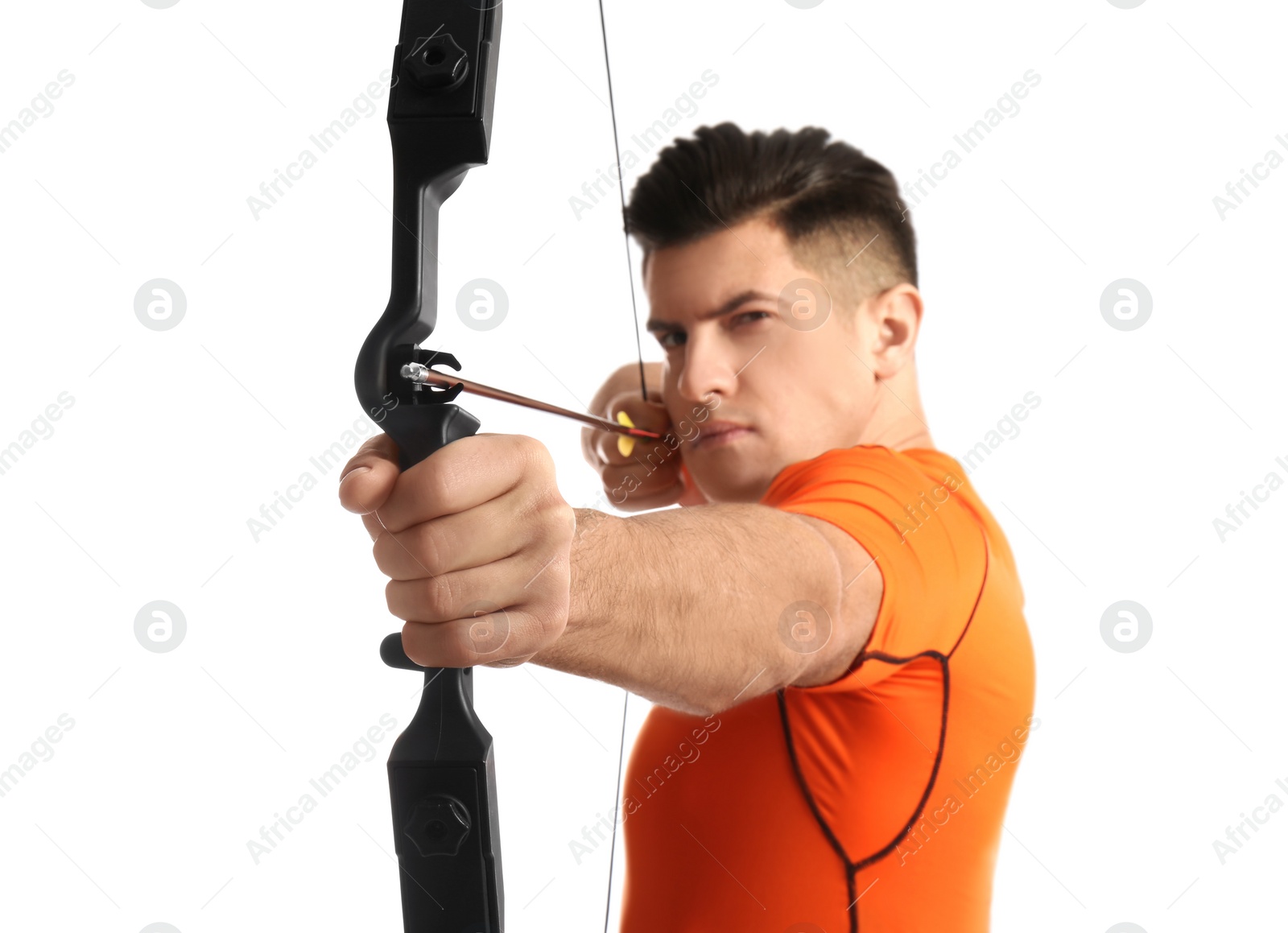 Photo of Man with bow and arrow practicing archery against white background, focus on hand