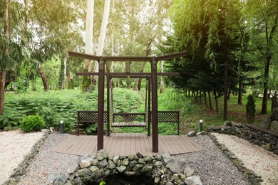 Beautiful brown metal swing in tranquil park