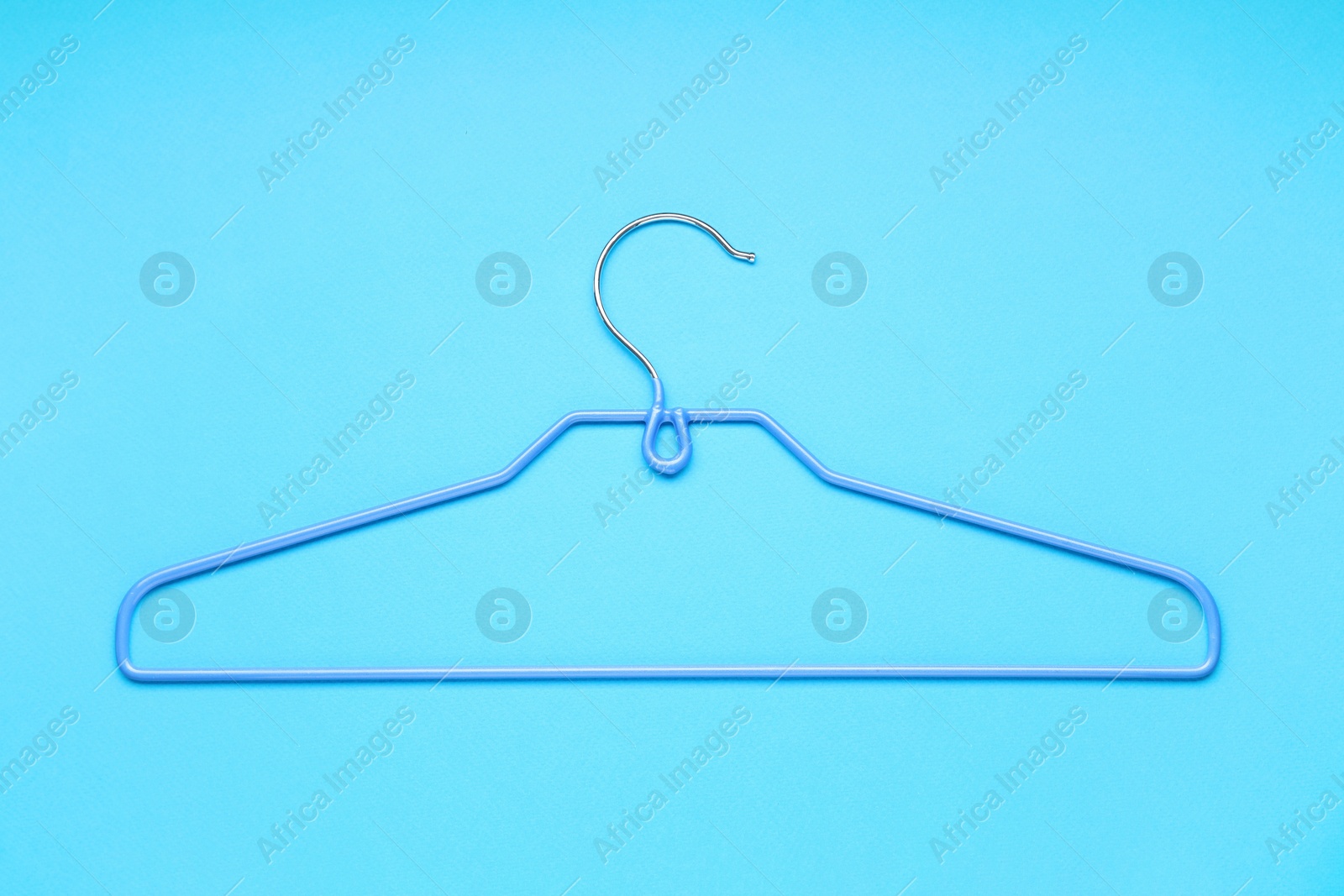 Photo of Empty hanger on light blue background, top view