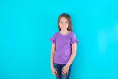 Little girl in t-shirt on color background. Mockup for design