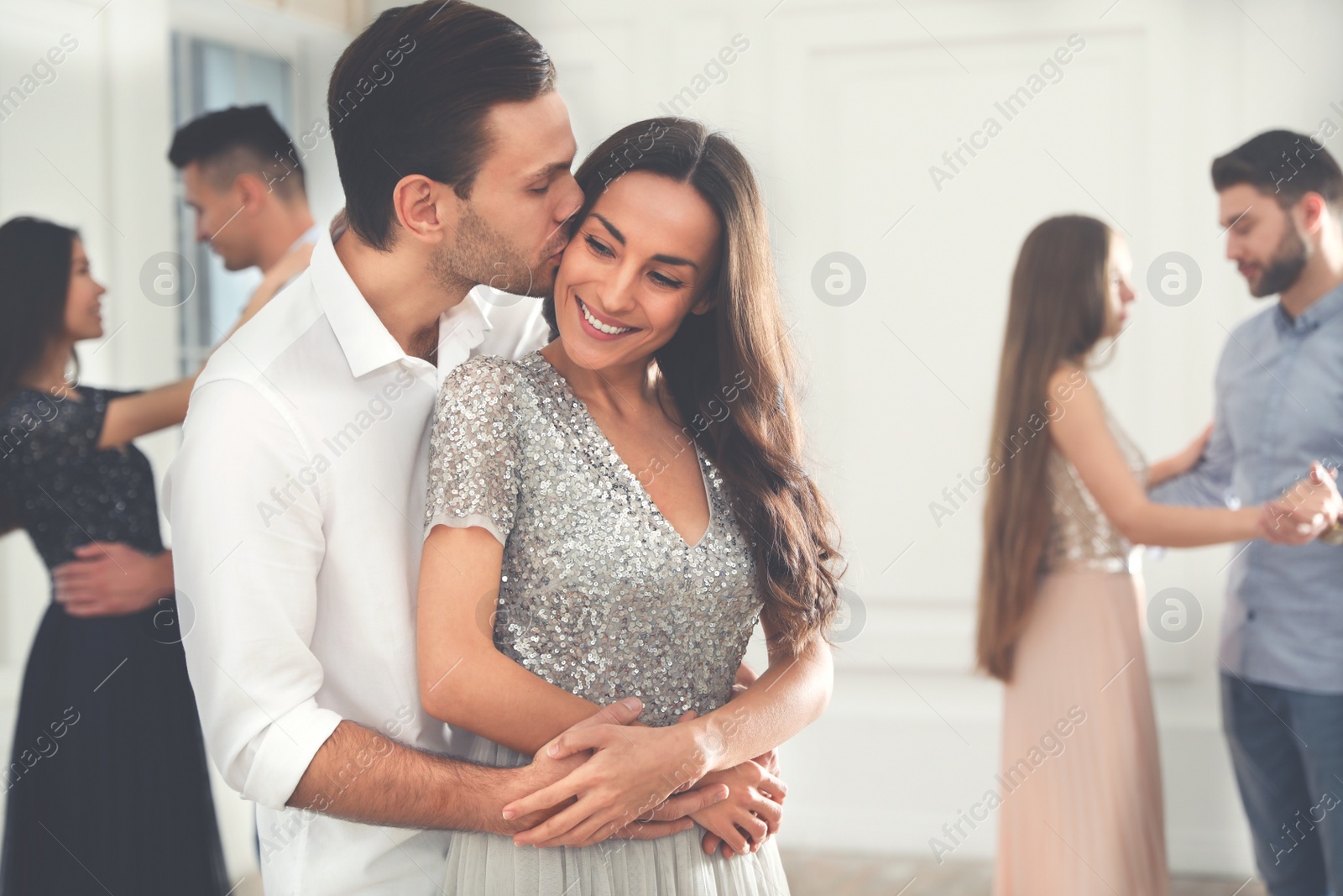 Photo of Lovely young couple dancing together at party