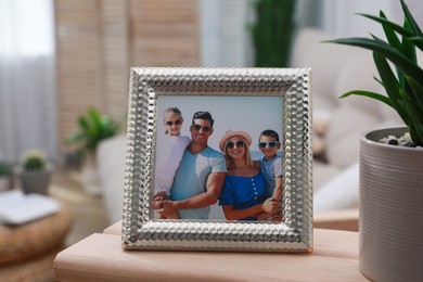 Photo of Framed family photo on wooden table in living room