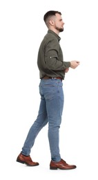 Photo of Man in shirt and jeans walking on white background