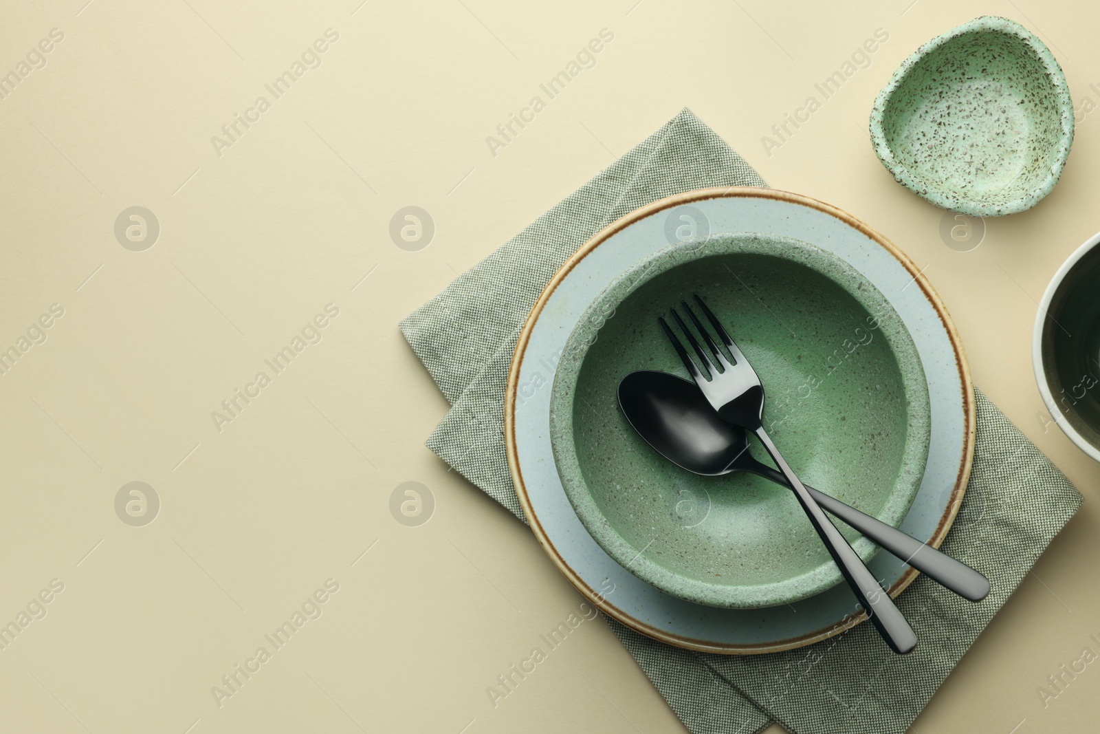 Photo of Stylish empty dishware and cutlery on beige background, flat lay. Space for text