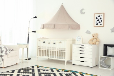 Photo of Stylish baby room interior with crib