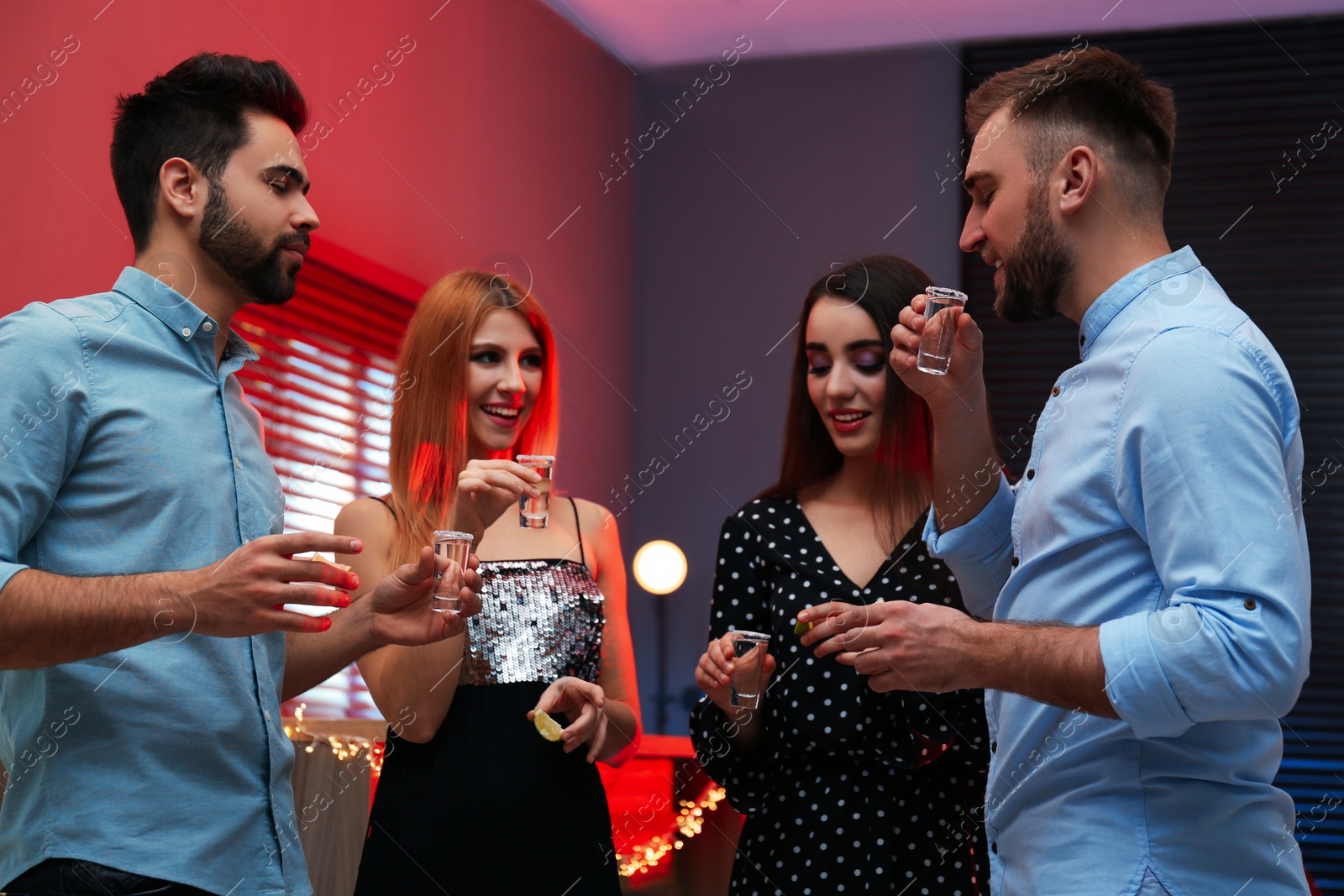 Photo of Young people drinking Mexican Tequila shots in bar