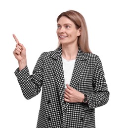 Beautiful happy businesswoman pointing at something on white background