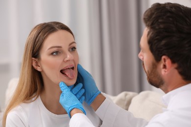 Photo of Doctor examining woman`s oral cavity in hospital