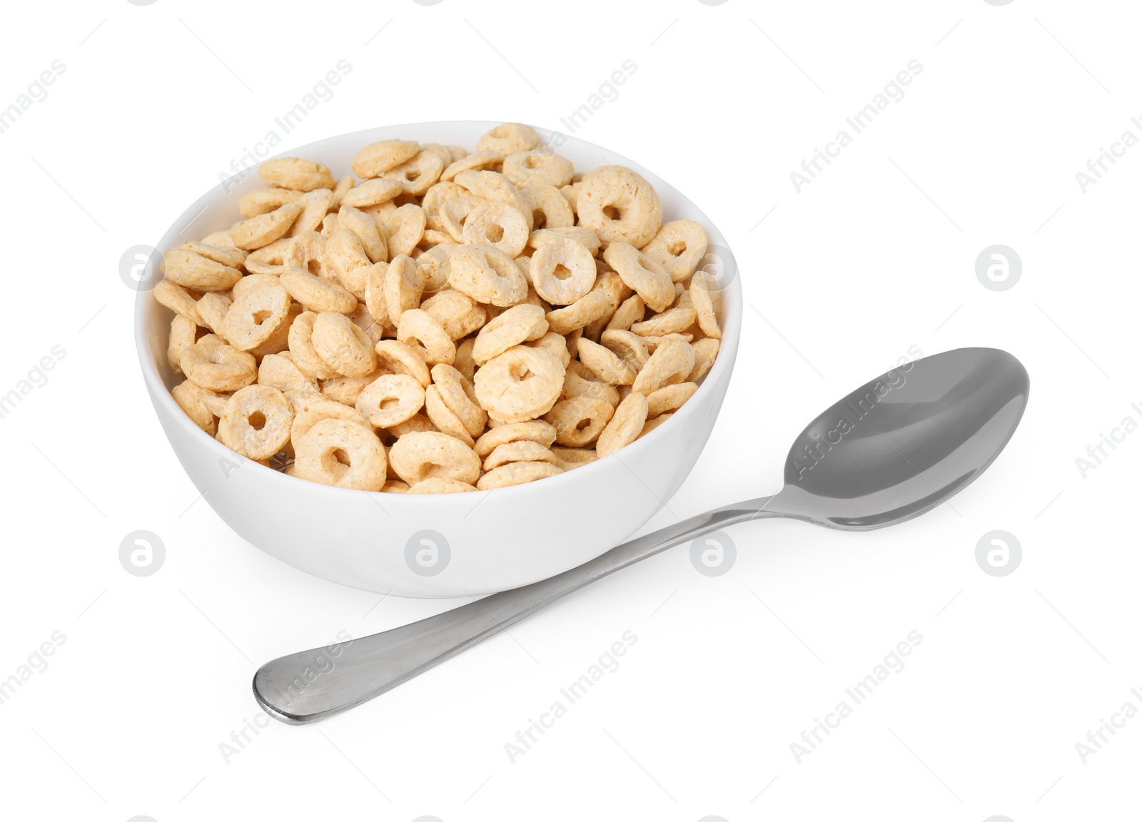 Photo of Tasty cereal rings in bowl and spoon isolated on white