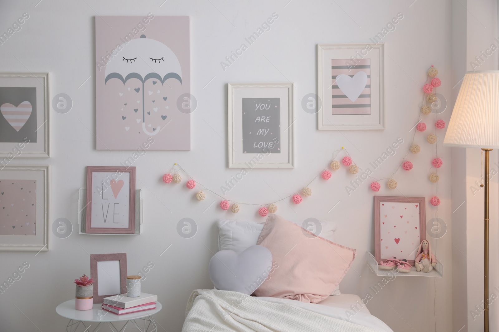 Photo of Modern teenager's room interior with comfortable bed and beautiful pictures