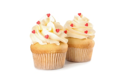 Tasty cupcakes with heart shaped sprinkles for Valentine's Day on white background