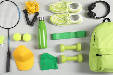 Different sports equipment on light grey background, flat lay