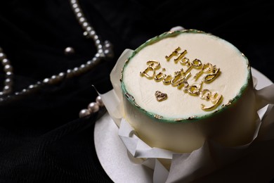 Delicious decorated Birthday cake on black background, closeup