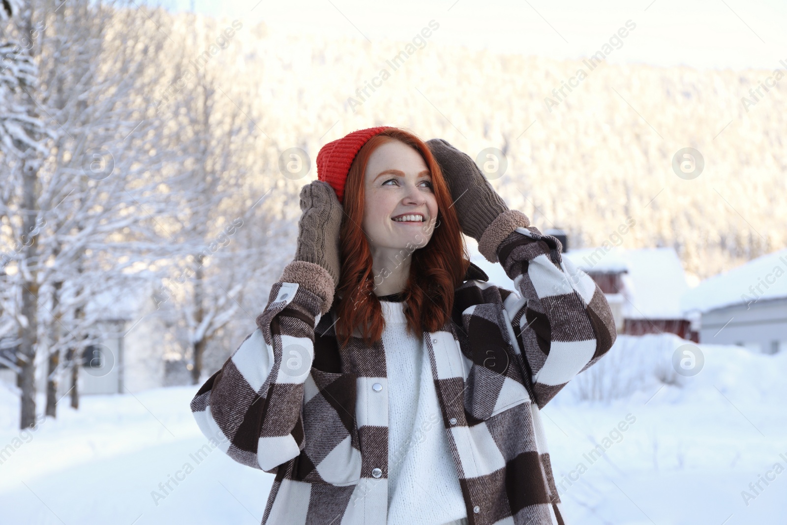 Photo of Portrait of beautiful young woman on snowy day outdoors. Winter vacation