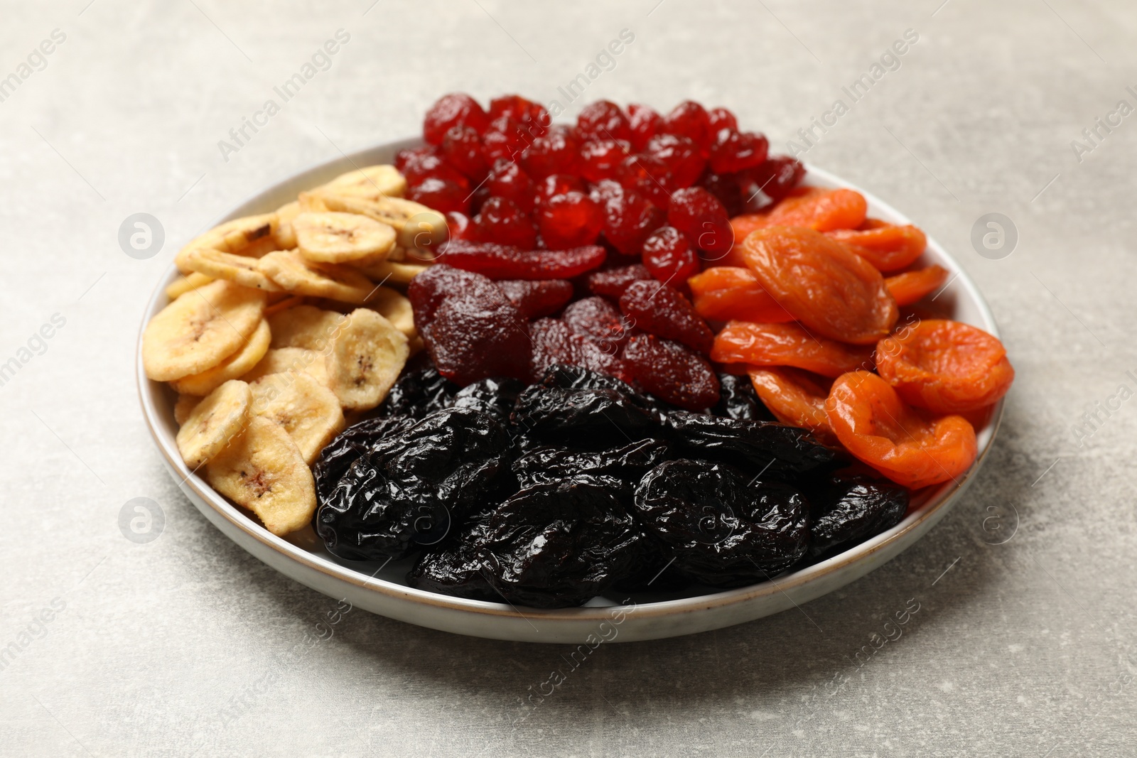 Photo of Delicious dried fruits on grey table, closeup