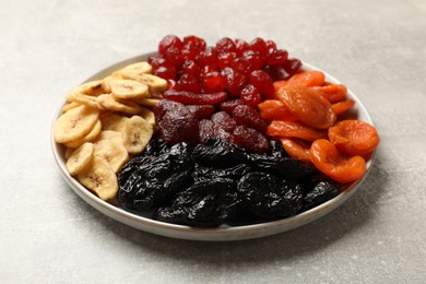 Delicious dried fruits on grey table, closeup