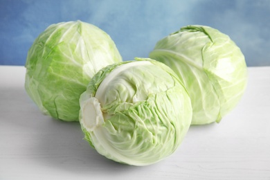 Whole cabbages on white table. Healthy food