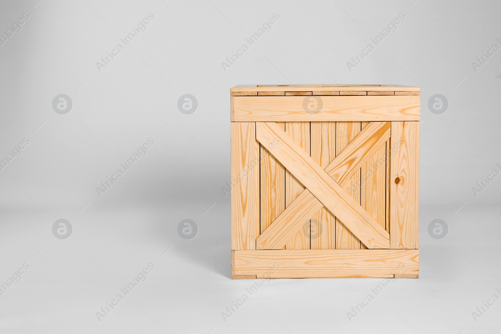 Photo of Closed wooden crate on grey background. Space for text