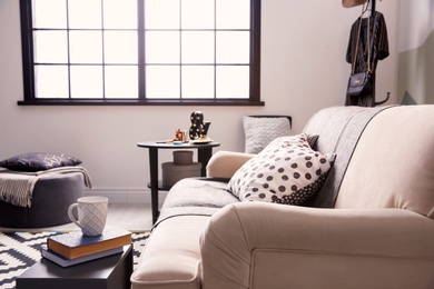 Photo of Comfortable sofa with soft pillows in living room