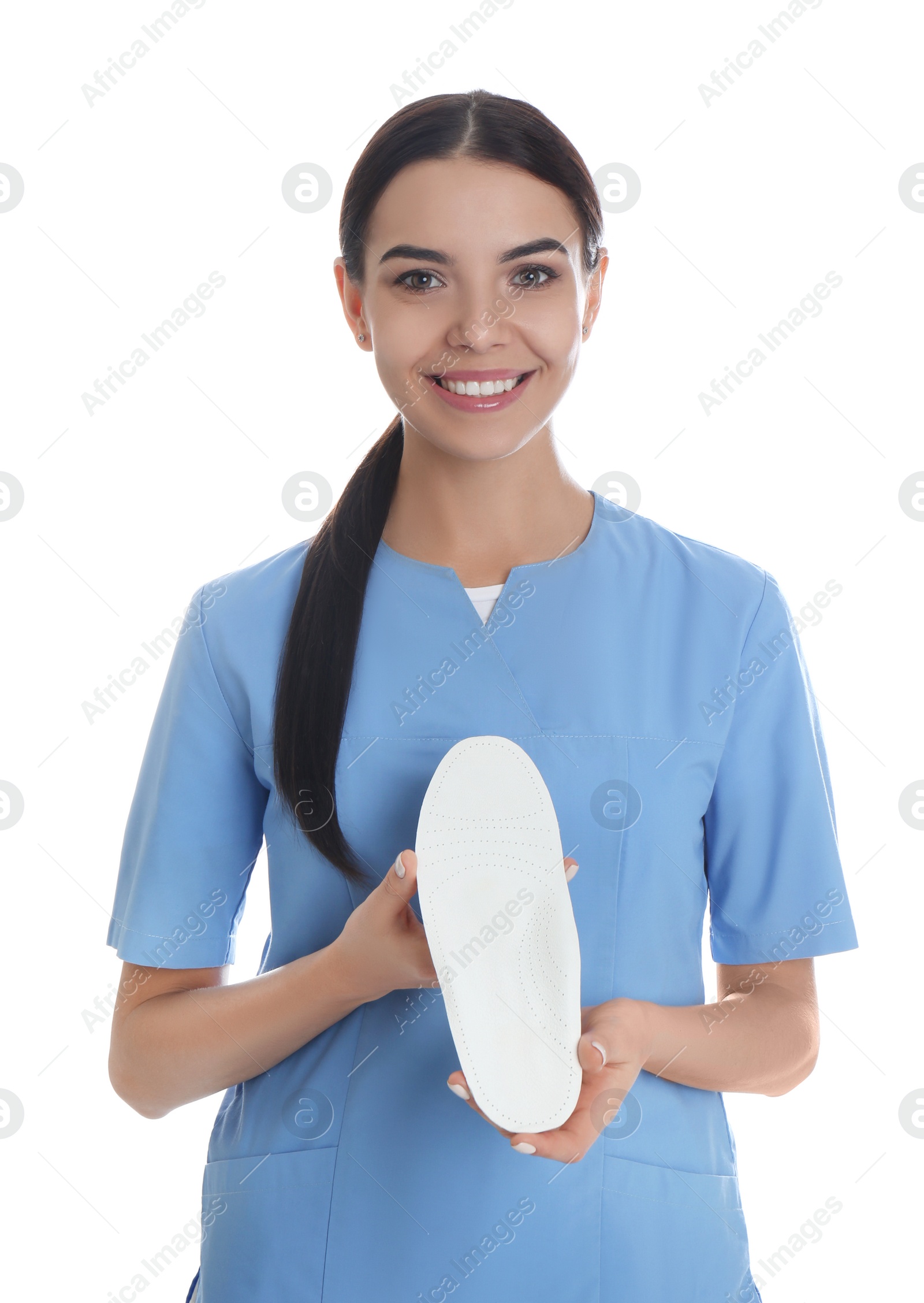 Photo of Female orthopedist showing insole on white background