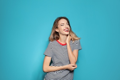 Photo of Beautiful young woman with healthy long blonde hair on color background