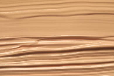 Texture of liquid skin foundation as background, closeup