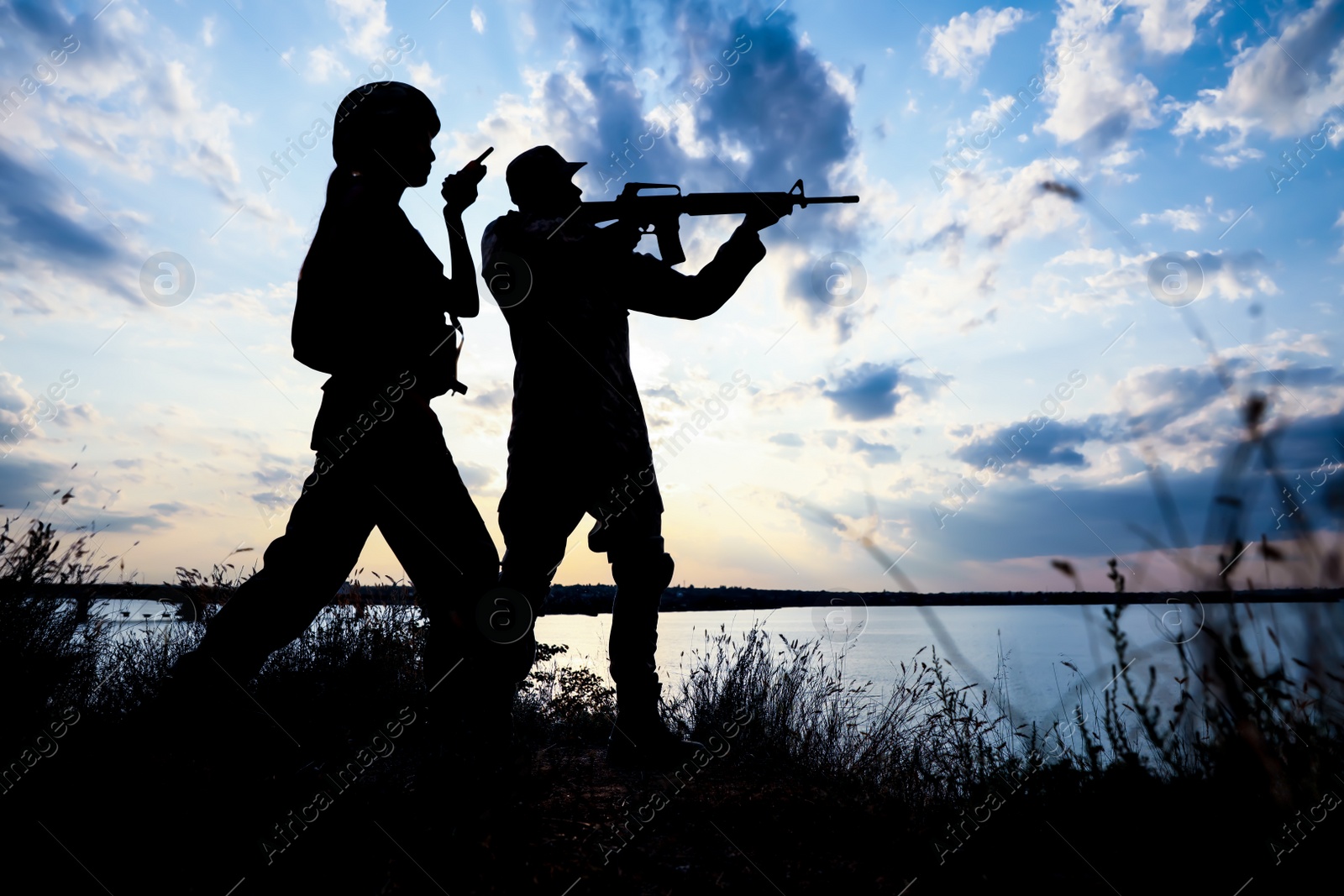 Photo of Soldiers in uniform patrolling outdoors. Military service