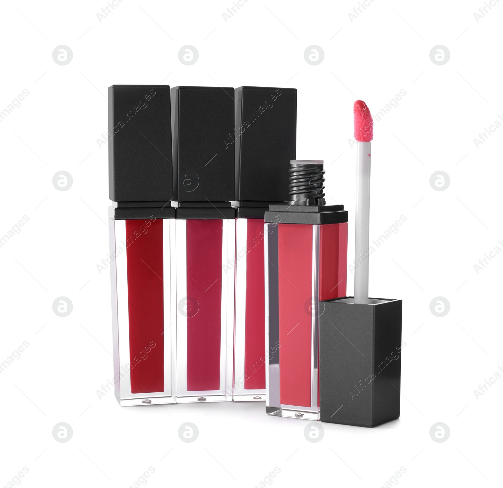 Photo of Different liquid lipsticks on white background. Makeup product