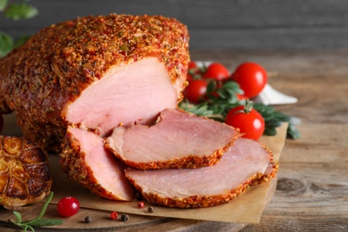 Photo of Homemade delicious ham on wooden table, closeup. Festive dinner