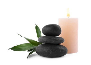Photo of Stack of spa stones, bamboo and candle isolated on white