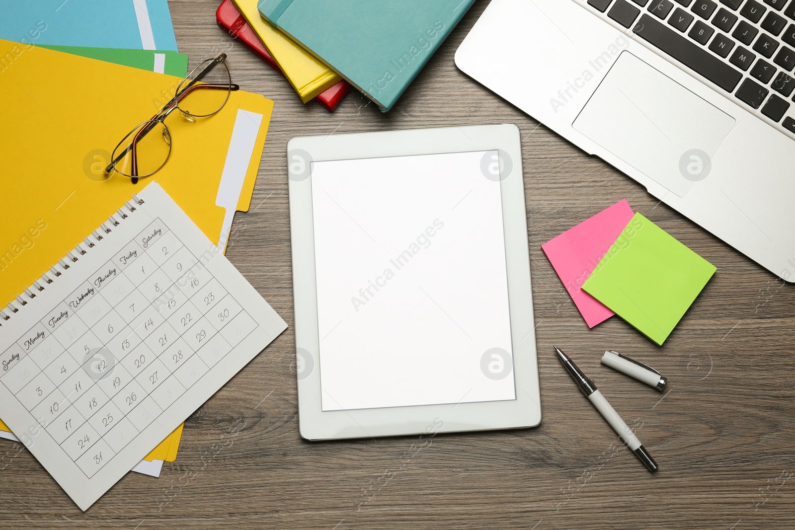 Photo of Modern gadgets and office supplies on wooden table, flat lay. Distance learning