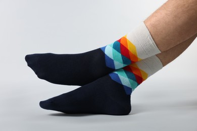 Photo of Man in stylish colorful socks on white background, closeup