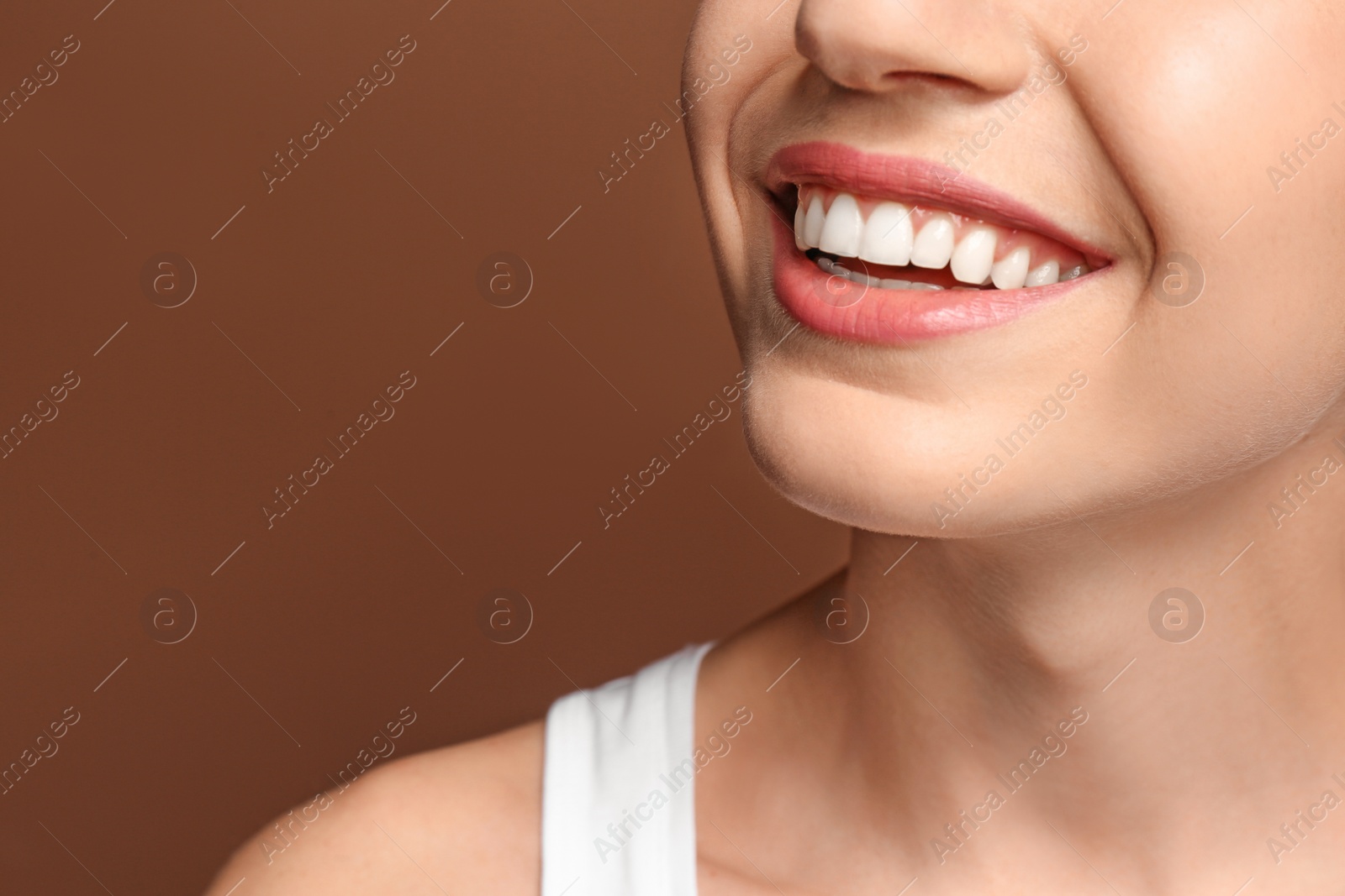 Photo of Young woman with beautiful smile on color background. Teeth whitening