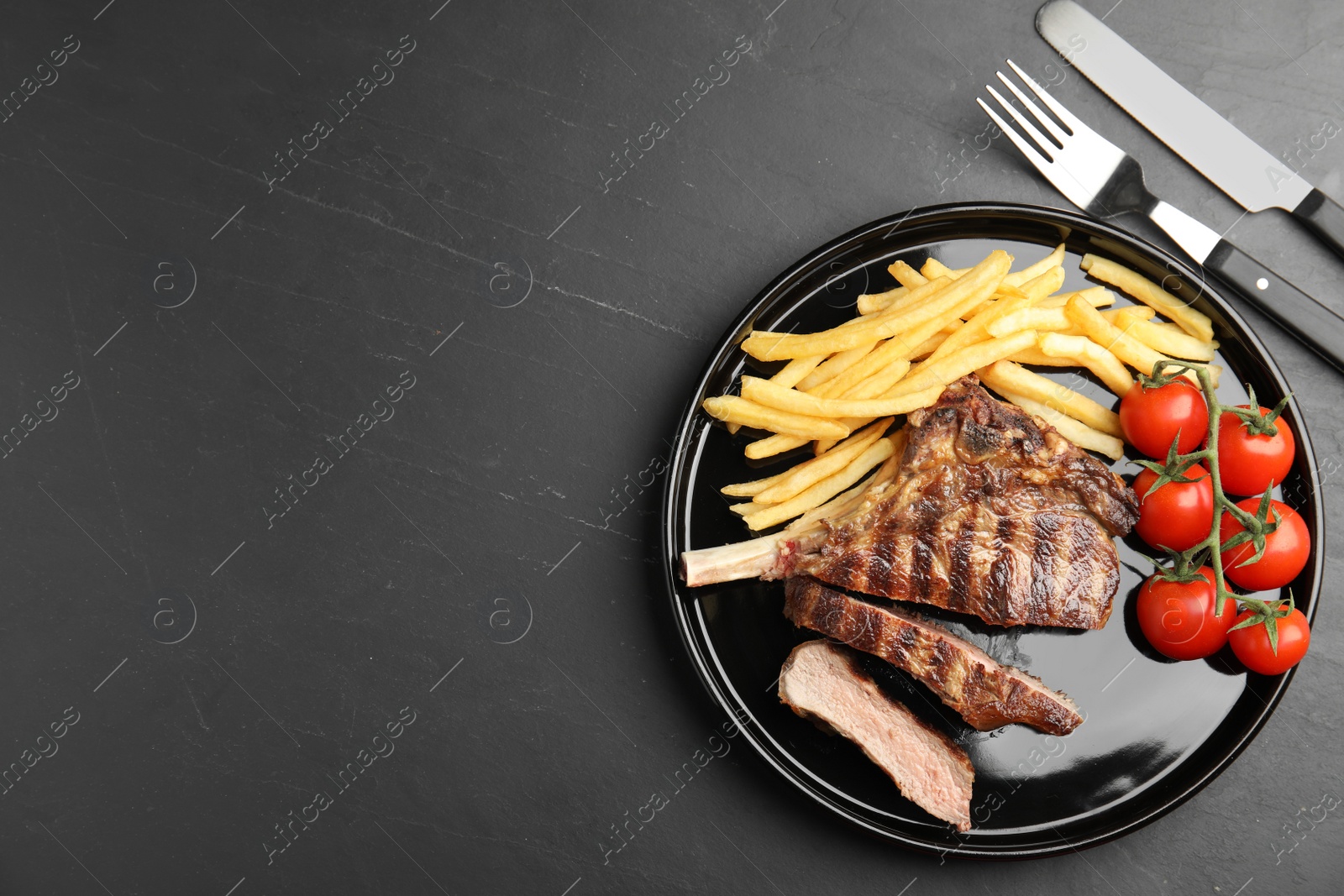 Image of Tasty grilled steak served on black table, flat lay. Space for text 