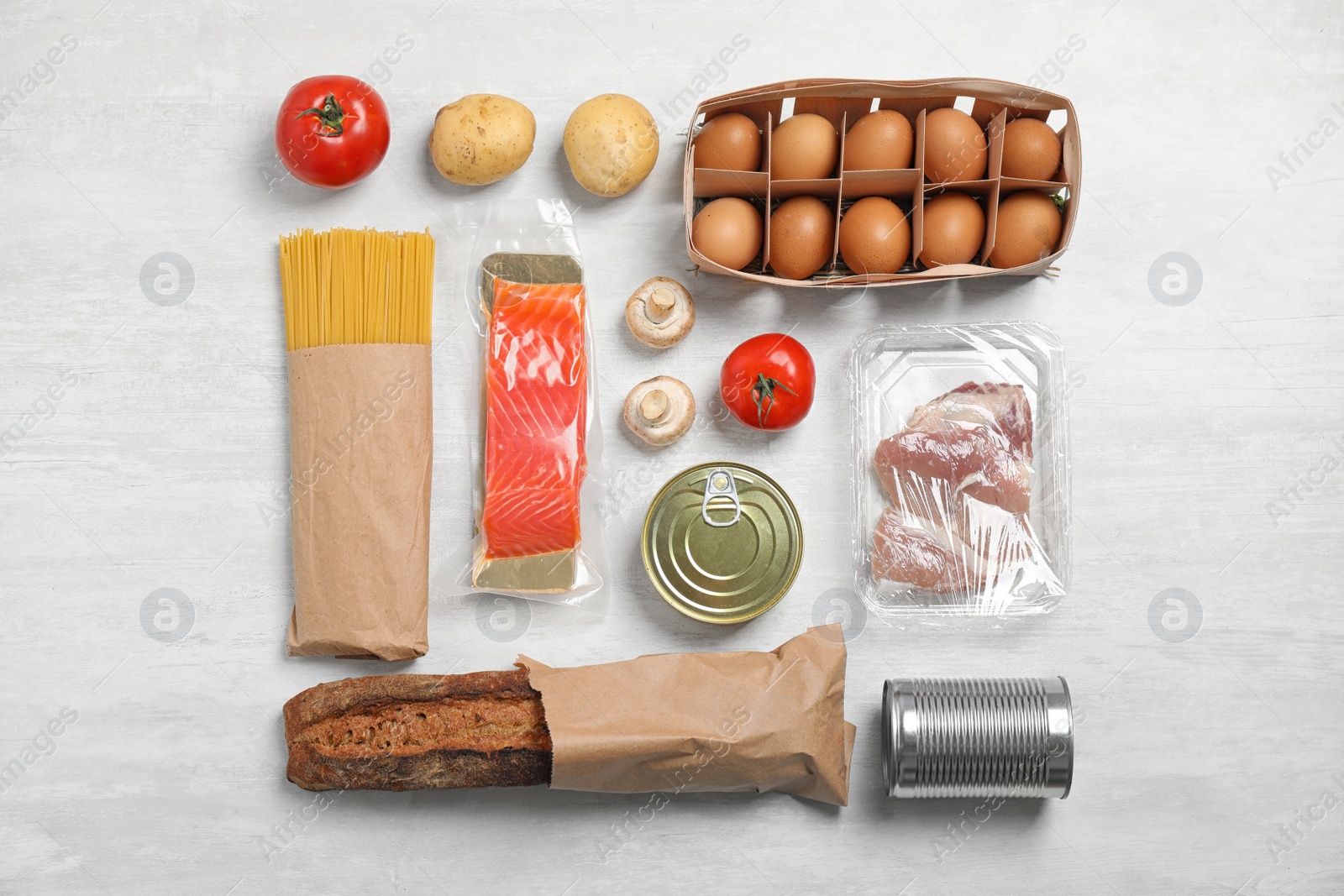 Photo of Fresh vegetables and other products on light grey background, flat lay
