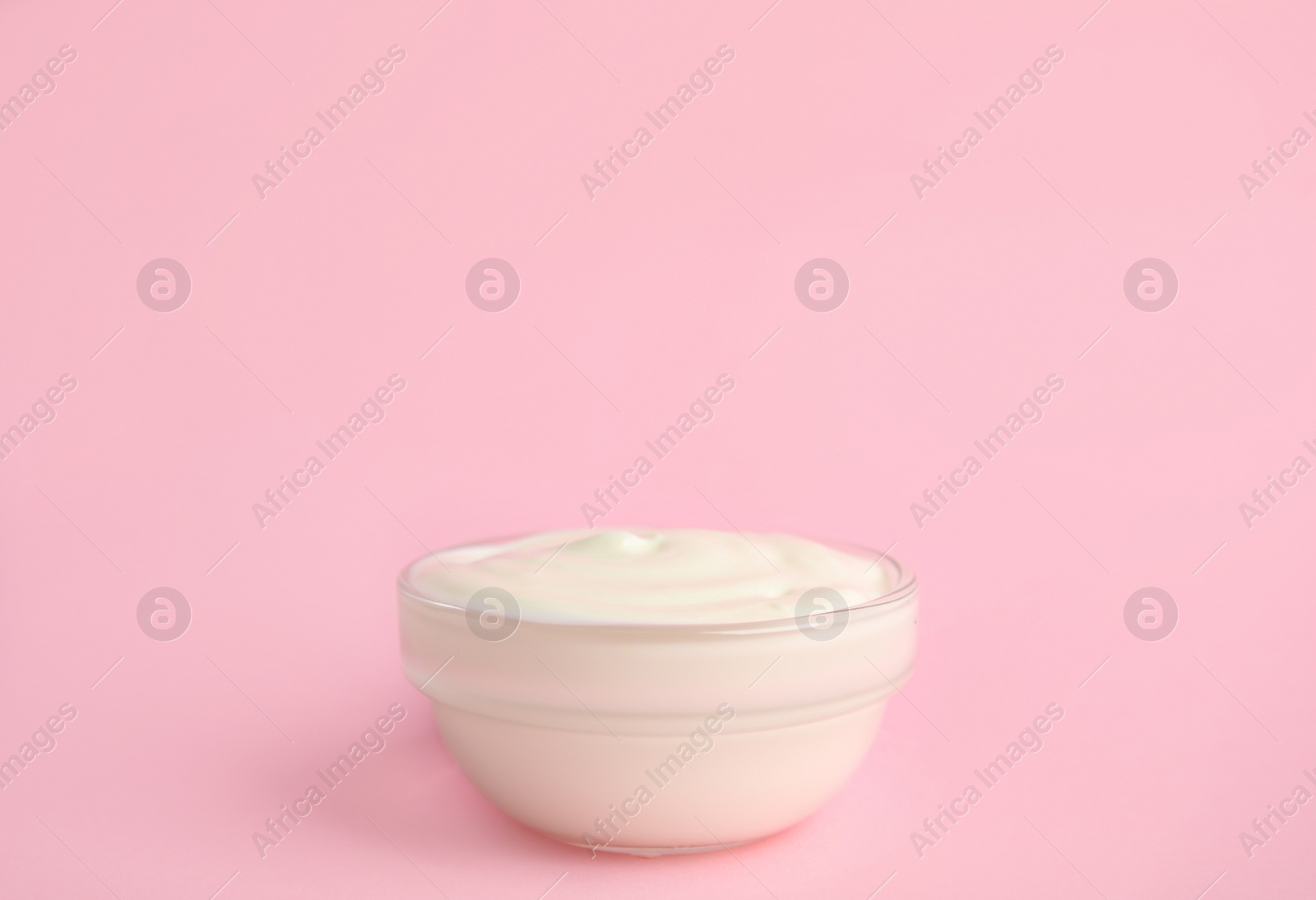 Photo of Tasty organic yogurt on pink background. Space for text