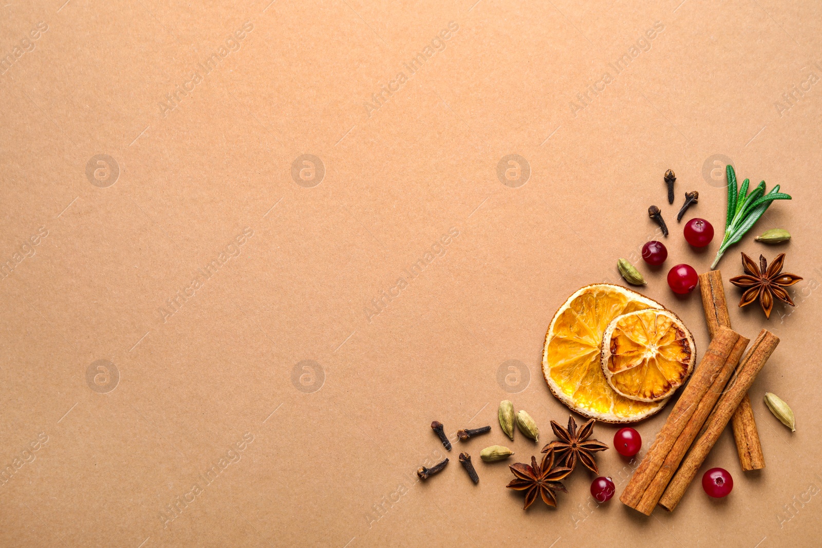 Photo of Different mulled wine ingredients on brown background, flat lay. Space for text