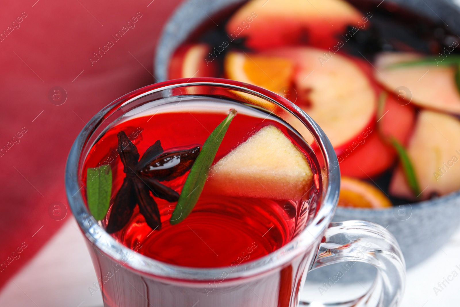 Photo of Tasty mulled wine with spices on table, closeup