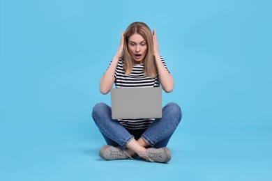 Photo of Emotional woman with laptop on light blue background