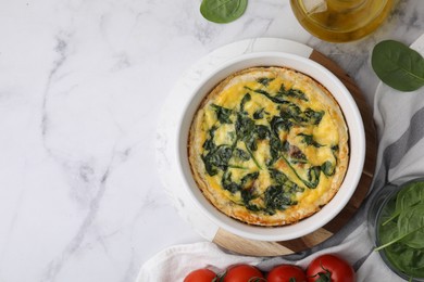 Photo of Delicious pie with spinach on white marble table, flat lay. Space for text