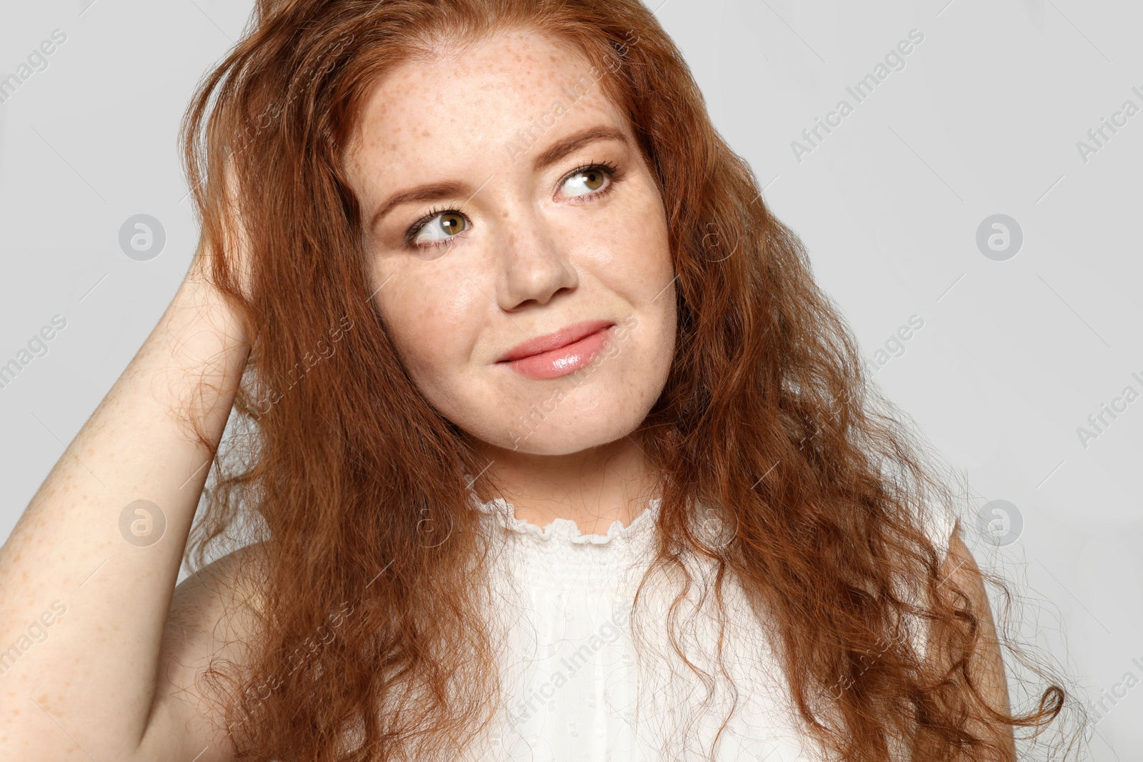 Photo of Portrait of young woman with beautiful face on grey background, closeup